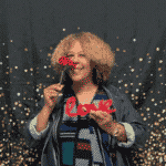 ms. campbell smelling a rose