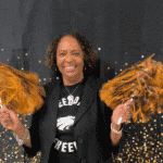 Ms. Jenkins shaking pom poms