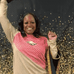 Ms. Riley tossing a graduation cap. 