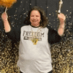 Ms. Santos shaking a baton