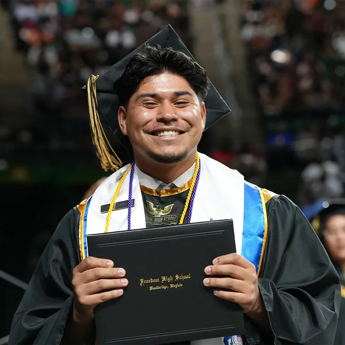 Freedom HS student holding a diploma