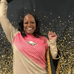Ms. Riley throwing a graduation cap in the air